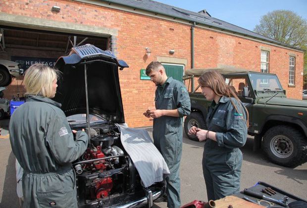 Apprentices working on a classic car